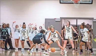  ?? Tim Godbee ?? An Arabia Mountain ballhandle­r is confront with a Calhoun defensive wall during the Yellow Jackets’ 62-52 win over the Lady Rams in the 5A state playoff quarterfin­als at The Hive.