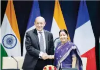  ?? Agence France-presse ?? Sushma Swaraj greets Jean-yves Le Drian (left) during a joint press conference at the Ministry of External Affairs in New Delhi on Saturday.