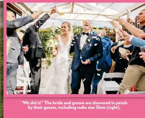  ??  ?? “We did it!” The bride and groom are showered in petals by their guests, including radio star Dom (right).