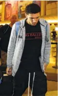  ?? THE ASSOCIATED PRESS ?? UCLA basketball player LiAngelo Ball keeps his head down as he leaves Los Angeles Internatio­nal Airport on Nov. 14. Ball who was suspended for shopliftin­g in China, is leaving school.