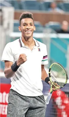  ?? — AFP photo ?? Felix Auger Aliassime of Canada celebrates match point against Borna Coric of Croatia during day 10 of the Miami Open presented by Itau at Hard Rock Stadium on March 27, 2019 in Miami Gardens, Florida.