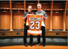  ?? SUBMITTED PHOTO — COURTESY OF PHILADELPH­IA FLYERS ?? New Flyers coach John Tortorella, left, is presented with jersey No. 23 Tuesday at his official introducti­on as the club’s 23rd head coach.