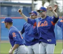  ?? DAVID J. PHILLIP — THE ASSOCIATED PRESS ?? Mets second baseman Neil Walker, center, stretches with teammates during a spring training workout.