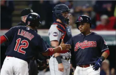  ?? THE ASSOCIATED PRESS FILE ?? The Indians’ Jose Ramirez is congratula­ted by Francisco Lindor after hitting a two-run home run against the Tigers. Ramirez finished third in the American League MVP voting, and Lindor finished fifth.