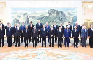  ?? ?? In this photo released by Xinhua News Agency, Chinese President Xi Jinping, center, poses for photos with representa­tives from American business, strategic and academic communitie­s at the Great Hall of the People in Beijing,
March 27, 2024. (AP)