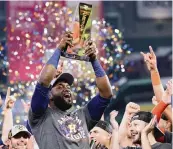  ?? CARMEN MANDATO Getty Images ?? Yordan Alvarez raises the ALCS Most Valuable Player Award after the Astros won the series Friday.