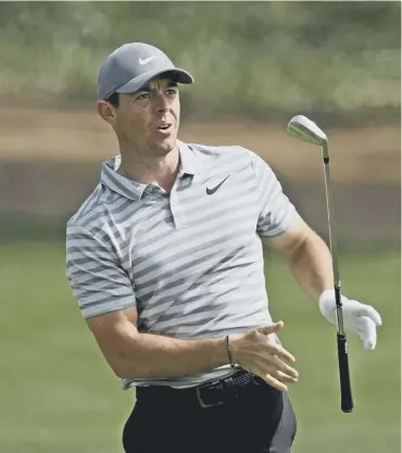  ??  ?? 0 Rory Mcilroy reacts to his second shot on the ninth hole during his opening round in Dubai.