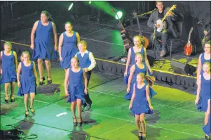  ?? JEREMY FRASER/CAPE BRETON POST ?? Members of La Swing du Suête perform as the band Coig plays in the background during the Celtic Colours Internatio­nal Festival opening concert at Centre 200 in Sydney on Friday.