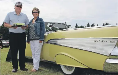  ?? MILLICENT MCKAY/JOURNAL PIONEER ?? Norman and Joanne Smith stand next to their 1957 Chevrolet Bel Air while holding the model car that started it all.