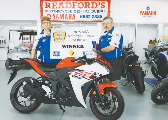  ??  ?? Dave and Margaret Readford with the trophy and signage they can now proudly display in their business after earning the 2015 NSW MTA Motorcycle Dealership of the Year award