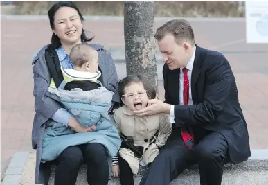  ?? HA KYUNG-MIN/NEWSIS VIA THE ASSOCIATED PRESS ?? Robert Kelly, a political-science professor at Pusan National University in Busan, South Korea, waits for a press conference with his wife Jung-a Kim and children James and Marion last Wednesday.