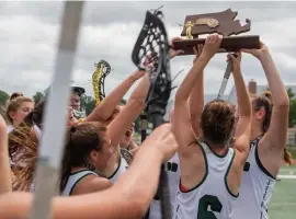  ?? AMaNDa saBga / BostoN heraLD ?? ‘CHIP ON OUR SHOULDER’: Westwood girls lacrosse celebrates their Div. 1 South sectional title over rival Notre Dame Academy on Sunday at Westwood High School.