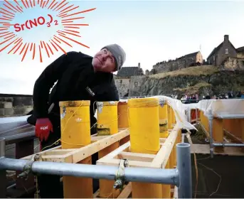  ??  ?? Pyrotechni­cian Shaun Gibson setting up some of the 2.6 tonnes of fireworks along the ramparts of Edinburgh Castle, ahead of the Hogmanay fireworks display.