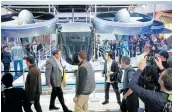  ?? Picture: GETTY IMAGES/MARIO TAMA ?? Attendees of CES 2020 walk near a full-scale mock-up of the Bell Nexus 4EX air taxi concept.