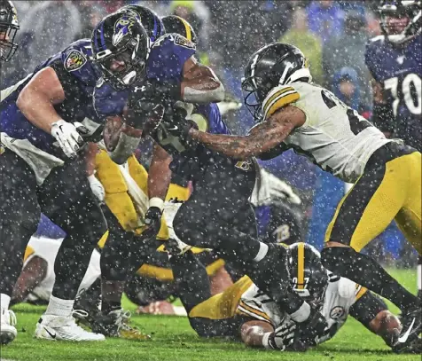  ?? Peter Diana/Post-Gazette photos ?? Neither the weather nor the Steelers could do much to stop the Ravens backups — Justice Hill in this instance — a week ago on the soggy grounds of M&T Bank Stadium in Baltimore.