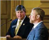  ?? ALYSSA POINTER/ALYSSA. POINTER@AJC. COM ?? State Sen. Larry Walker III (left) listens as Chris Riley, chief of staff for Gov. Nathan Deal, explains the jet fuel bill to senators on Friday.