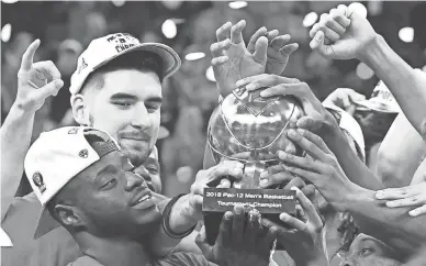  ?? STEPHEN R. SYLVANIE/USA TODAY SPORTS ?? Arizona guard Rawle Alkins, left, holds the Pac-12 Tournament championsh­ip trophy with teammates after the Wildcats defeated the USC Trojans 75-61 on Saturday night.