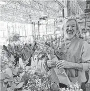  ??  ?? Curbside Chronicle vendor Art Reyes sells flowers inside Leadership Square in downtown Oklahoma City.