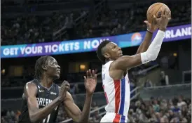  ?? PHELAN M. EBENHACK — THE ASSOCIATED PRESS ?? Detroit Pistons guard Hamidou Diallo (6) goes up for a shot as Orlando Magic center Bol Bol, left, defends during the first half of Thursday’s game in Orlando, Fla.