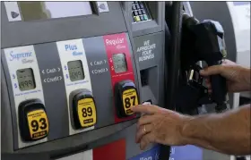  ?? MARTA LAVANDIER — THE ASSOCIATED PRESS ?? A customer pumps gas at an Exxon gas station Tuesday in Miami. U.S consumers have so far defied higher prices for gas, food, and rent and have been spending more in 2022, providing crucial support to the economy. How long that can continue will be one of the key factors affecting the economy and inflation this year.