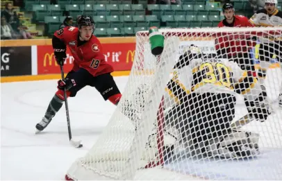  ?? CITIZEN PHOTO BY JAMES DOYLE ?? Prince George Cougars forward Ethan Browne looks to make a play at the net against Brandon Wheat Kings goaltender Ethan Kruger on Tuesday night at CN Centre.