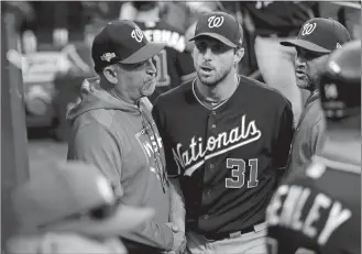  ?? MARK HUMPHREY/AP PHOTO ?? Washington Nationals pitcher Max Scherzer (31) talks with pitching coach Paul Menhart, left, and manager Dave Martinez after getting through the seventh inning of Game 2 of the NLCS against the St. Louis Cardinals on Saturday at St. Louis. Menhart is a former Fitch High School standout.