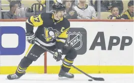  ?? CHARLES LECLAIRE ■ USA TODAY SPORTS ?? Pittsburgh Penguins centre Sidney Crosby handles the puck against the New York Rangers during the first period of Game 4 of the first round of the 2022 Stanley Cup Playoffs at PPG Paints Arena in Pittsburgh.