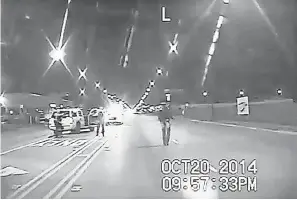  ?? AP ?? In this Oct. 20, 2014, frame from dash-cam video provided by Chicago police, Laquan McDonald, right, walks down the street moments before being shot.