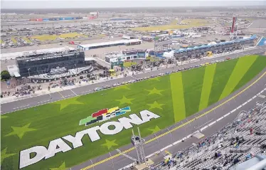  ?? ASSOCIATED PRESS ?? Drivers sit on pit road while waiting out a rain delay on Sunday at Daytona Internatio­nal Speedway. NASCAR is all in on sports wagering this year after implementi­ng gambling guidelines for drivers and team members.