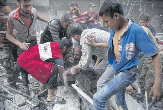  ??  ?? MORE HEARTBREAK: A man cries over the body of his daughter during rescue efforts after government air strikes in Aleppo last week.