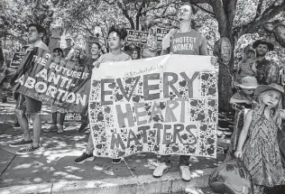  ?? Sergio Flores / Getty Images ?? Anti-abortion activists gather for a rally near the gate of the Texas Capitol last week.