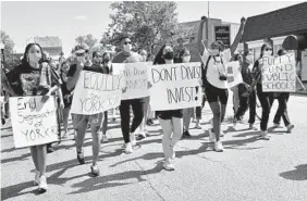  ??  ?? Celeste O’Connor, far left, and Mecca McDonald, with arms raised, both seniors at Johns Hopkins University, and other protesters march north Saturday on York Road.