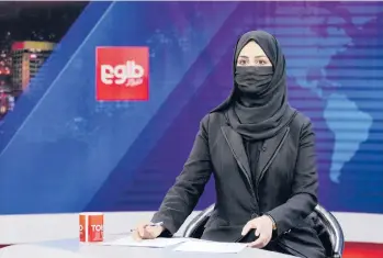  ?? EBRAHIM NOROOZI/AP ?? Taliban order: TV anchor Khatereh Ahmadi wears a face covering as she reads the news Sunday on TOLO NEWS in Kabul, Afghanista­n. Taliban rulers began enforcing an order issued Thursday requiring all female news anchors in the country to cover their faces while on-air. The move is part of a hard-line shift drawing condemnati­on from rights activists.