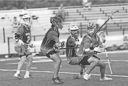  ?? SARAH BLOOM/SPECIAL TO THE ASBURY PARK PRESS ?? Red Bank Regional senior and North mid Henry Spencer plays against tight defense, from left, John McCurry (Wall), Luke Barber (Toms River East) and James Vitale (St. Rose) in the Shore Conference Senior All Star lacrosse game on June 19.