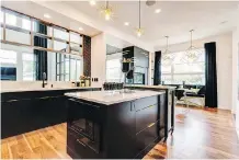  ??  ?? The kitchen in the dream home is spacious and airy and features stone countertop­s and built-in appliances.