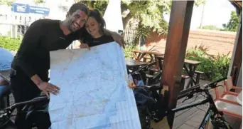  ?? Picture: JON HOUZET ?? A GOOD BREAK: Showing the map they use to plot their journey, Ivan Martinez and Manon Saenz relax for a drink at Kenny’s in Port Alfred on Saturday after a hard day’s cycling, during their marathon trek across South Africa