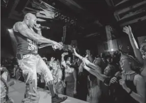  ?? Steve Peterson photos, Sepcial to The Denver Post ?? Flo Rida performs while handing out roses to the ladies at the Nightshine Gala, which was hosted by the Denver Health Foundation at the Hyatt Regency Convention Center.