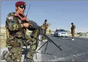  ?? ASSOCIATED PRESS ?? Afghan National Army soldiers stand guard at a checkpoint on the outskirts of Kabul, Afghanista­n, Monday. President Donald Trump said the U.S. would continue its efforts in Afghanista­n.