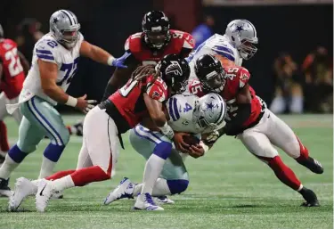  ?? Associated Press ?? Falcons defensive end Adrian Clayborn and linebacker Deion Jones sack Cowboys quarterbac­k Dak Prescott during the first quarter in an NFL football game on Sunday in Atlanta.