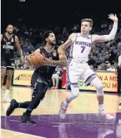  ?? EZRA SHAW/TNS FILE ?? Melo Trimble of Australian team Melbourne United drives on Sacramento’s Kyle Guy in an exhibition game Oct. 16.