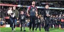  ??  ?? Manu Vatuvei and his family walk out on to the pitch before kickoff. David Skipwith