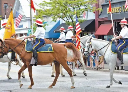  ?? STAFF PHOTOS BY CHRIS CHRISTO ?? MARCHING ON: The National Lancers cavalry, above, marches during the Newton Memorial Day parade yesterday. At left, the Uncle Sam Patriot Jazz Band performs patriotic tunes at the parade.