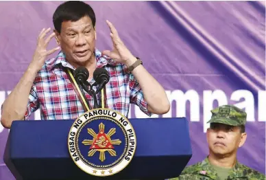  ?? (Richard Viñas) ?? NO TO ‘INDOLENT’ BUREAUCRAT­S – Speaking at the ground-breaking ceremony of Scout Ranger Ville in San Miguel, Bulacan, Wednesday, the President says he prefers to appoint ex-military officers to government positions because unlike ‘indolent’...