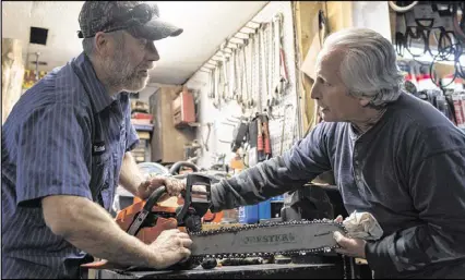  ?? DAVID BARNES / AJC ?? Dave Russo (right), a retiree, talks with Richard Yarber, owner of Yarber Small Engines in Homer. “We all voted for Trump because he didn’t come out and sugarcoat anything,” Yarber said.