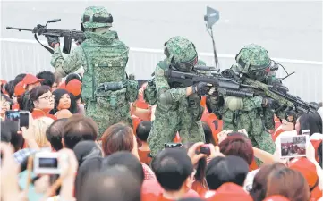  ?? — Reuters photo ?? Singapore Armed Forces personnel perform a drill during National Day celebratio­ns.