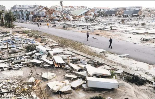  ?? Gerald Herbert / Associated Press ?? Rescue personnel on Thursday search amidst debris in the aftermath of Hurricane Michael in Mexico Beach, Fla.