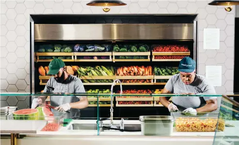  ??  ?? 
 FINAL PREP
In Brooklyn, Sweetgreen employees Darren Mahabir (bottom photo, left) and Meesh Hernandez (right) peel, chop, and prep the raw ingredient­s for Sweetgreen salads. Top left: Crumbled goat cheese and shredded greens. Top right: Roasted trout...