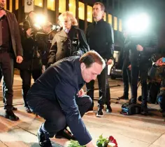  ??  ?? CARNAGE: Left, bodies lie in the street after Friday’s attack; above, Swedish PM Stefan Lofven places flowers at the scene; top right, a woman weeps at the crash site yesterday; above right, the damaged beer truck is towed away