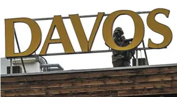  ?? — AP ?? Security detail: Special police on guard on the roof of the congress hotel at the 51st annual meeting of the World Economic Forum in Davos, where European Central Bank president Christine Lagarde said a recession isn’t the central bank’s base-line scenario.