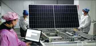  ?? PROVIDED TO CHINA DAILY ?? Employees assemble photovolta­ic panels at a production facility in Liupanshui, Guizhou province.